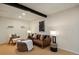Modern living room featuring a brown leather sofa, stylish decor, and a contemporary design at 8174 Field Cir, Arvada, CO 80005