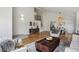 Bright living room with hardwood floors, high ceilings, and open layout to the dining area at 8174 Field Cir, Arvada, CO 80005