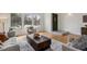 Bright living room featuring hardwood floors, a vaulted ceiling, and large windows at 8174 Field Cir, Arvada, CO 80005