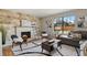 Cozy living room with fireplace, stone wall, natural light, and modern decor at 8174 Field Cir, Arvada, CO 80005