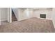 A finished basement with carpet, a white brick fireplace, and ample space for entertainment at 3338 W Arlington Ave, Littleton, CO 80123