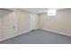 A clean basement space features gray concrete floors and two white doors at 3338 W Arlington Ave, Littleton, CO 80123