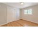 Cozy bedroom with hardwood floors, a closet, and bright natural light coming through the window at 3338 W Arlington Ave, Littleton, CO 80123