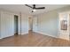 A bright bedroom with hardwood floors, white trim, a large window, closet and access to the ensuite bathroom at 3338 W Arlington Ave, Littleton, CO 80123