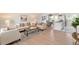 Inviting living room with hardwood floors, a stylish sofa, and an open layout to the kitchen and dining area at 3338 W Arlington Ave, Littleton, CO 80123