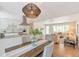 Stylish dining area with a kitchen view, granite counters, and a seamless transition to a comfortable living room at 3338 W Arlington Ave, Littleton, CO 80123