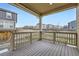 Covered back porch with a wooden deck and view of the backyard at 17530 E 95Th Ave, Commerce City, CO 80022