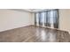 Bedroom with tray ceiling, wood-look floors, neutral walls, and windows covered in sheer curtains at 17530 E 95Th Ave, Commerce City, CO 80022