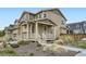 Inviting home featuring a covered porch, lush landscaping, and charming curb appeal in a desirable neighborhood at 17530 E 95Th Ave, Commerce City, CO 80022