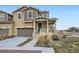 Charming home featuring a welcoming porch, well-manicured lawn, and attached garage, perfect for modern living at 17530 E 95Th Ave, Commerce City, CO 80022