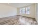 Bright, airy living room with hardwood floors, recessed lighting, and large windows, offering a modern and comfortable living space at 17530 E 95Th Ave, Commerce City, CO 80022