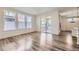 Bright living area featuring sleek hardwood floors, recessed lighting, and sliding glass doors leading to an outdoor space at 17530 E 95Th Ave, Commerce City, CO 80022