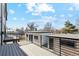 Wide balcony featuring wood flooring, a black metal railing, and an outdoor view of the yard at 2317 S Galapago St, Denver, CO 80223