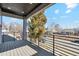 A view from the balcony with black metal railings overlooks the neighborhood street with bright blue skies at 2317 S Galapago St, Denver, CO 80223