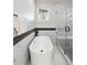 Modern bathroom showcasing a soaking tub and glass-enclosed shower at 2317 S Galapago St, Denver, CO 80223