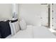Bright bedroom with a white comforter, stylish pillows, and a bedside lamp at 2317 S Galapago St, Denver, CO 80223