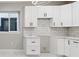 Bright kitchen featuring white cabinets, stainless steel hardware, white subway tile backsplash, and modern lighting at 2317 S Galapago St, Denver, CO 80223