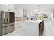 Spacious kitchen with white cabinets, stainless steel appliances, and a large island at 2317 S Galapago St, Denver, CO 80223