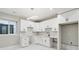 Bright kitchen featuring white cabinets, stainless steel hardware, white subway tile backsplash, and modern lighting at 2317 S Galapago St, Denver, CO 80223