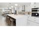 Beautiful kitchen boasts a large island, quartz countertops, and stainless steel appliances at 2317 S Galapago St, Denver, CO 80223
