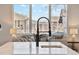 Close-up of kitchen island featuring a modern faucet and open concept floor plan at 2317 S Galapago St, Denver, CO 80223