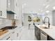 Bright kitchen with white cabinets, modern appliances, and a dining area at 2317 S Galapago St, Denver, CO 80223