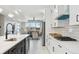 Open-concept kitchen with stainless appliances and view to the living room at 2317 S Galapago St, Denver, CO 80223