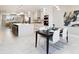 Bright kitchen with stainless steel appliances, a large island and a modern dining set at 2317 S Galapago St, Denver, CO 80223