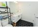 Well-lit bathroom showcasing modern vanity, hexagon tile flooring, and a contemporary mirror and wall art at 2876 W 53Rd Ave # 106, Denver, CO 80221