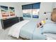 Bright bedroom with a wooden-framed bed, modern decor, and ample natural light at 2876 W 53Rd Ave # 106, Denver, CO 80221