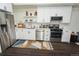 Modern kitchen with stainless steel appliances, white cabinets, and a stylish backsplash at 2876 W 53Rd Ave # 106, Denver, CO 80221