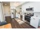 Stylish kitchen with stainless steel appliances, subway tile backsplash, and sleek white cabinetry at 2876 W 53Rd Ave # 106, Denver, CO 80221