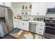 Modern kitchen featuring stainless steel appliances, white cabinets, subway tile, and open shelving at 2876 W 53Rd Ave # 106, Denver, CO 80221