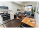 Modern living room featuring a gray sofa, wood floors, and a sliding glass door to a balcony at 2876 W 53Rd Ave # 106, Denver, CO 80221