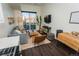 Cozy living room with a gray sectional sofa, a wood coffee table, and a view of the balcony at 2876 W 53Rd Ave # 106, Denver, CO 80221