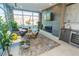 Bright living room with a fireplace, large windows, and modern furniture at 2876 W 53Rd Ave # 106, Denver, CO 80221