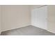 Neutral bedroom with gray carpeting and a double door closet provides a calming, spacious area at 1801 S Dunkirk St # 108, Aurora, CO 80017