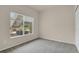 Cozy bedroom with neutral carpet, white trim, and a window view of the outdoors at 1801 S Dunkirk St # 108, Aurora, CO 80017