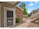 Entryway featuring pea gravel landscaping, manicured bushes, and a brick exterior at 1801 S Dunkirk St # 108, Aurora, CO 80017