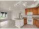 Open kitchen and living area with wood floors, stainless sink, and ample cabinet space provides a modern, inviting feel at 1801 S Dunkirk St # 108, Aurora, CO 80017