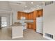Kitchen featuring wood cabinetry, modern appliances, breakfast bar and hardwood floors at 1801 S Dunkirk St # 108, Aurora, CO 80017