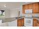 Modern kitchen with wooden cabinets, white appliances and spacious countertops creates a functional cooking and gathering space at 1801 S Dunkirk St # 108, Aurora, CO 80017