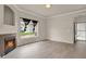 Living room with fireplace, light wood floors and view to backyard and front door at 1801 S Dunkirk St # 108, Aurora, CO 80017