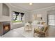 Living room with fireplace, light wood floors and view to backyard and front door at 1801 S Dunkirk St # 108, Aurora, CO 80017