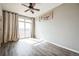 Sunlit bedroom with hardwood floors, large window, and access to an outdoor balcony at 18726 E Yale Cir # D, Aurora, CO 80013