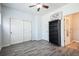 Bright bedroom with ample closet space, ceiling fan, and wood-look floors at 18726 E Yale Cir # D, Aurora, CO 80013