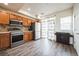 Modern kitchen with stainless steel appliances, tile backsplash, and natural light at 18726 E Yale Cir # D, Aurora, CO 80013