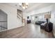 Bright living area with wood floors, staircase, stylish furniture, and modern lighting at 18726 E Yale Cir # D, Aurora, CO 80013
