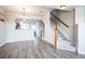 Open living space with hardwood floors, staircase, and a view of the kitchen at 18726 E Yale Cir # D, Aurora, CO 80013