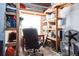 Organized storage space with shelving units, a desk, and an office chair at 18726 E Yale Cir # D, Aurora, CO 80013